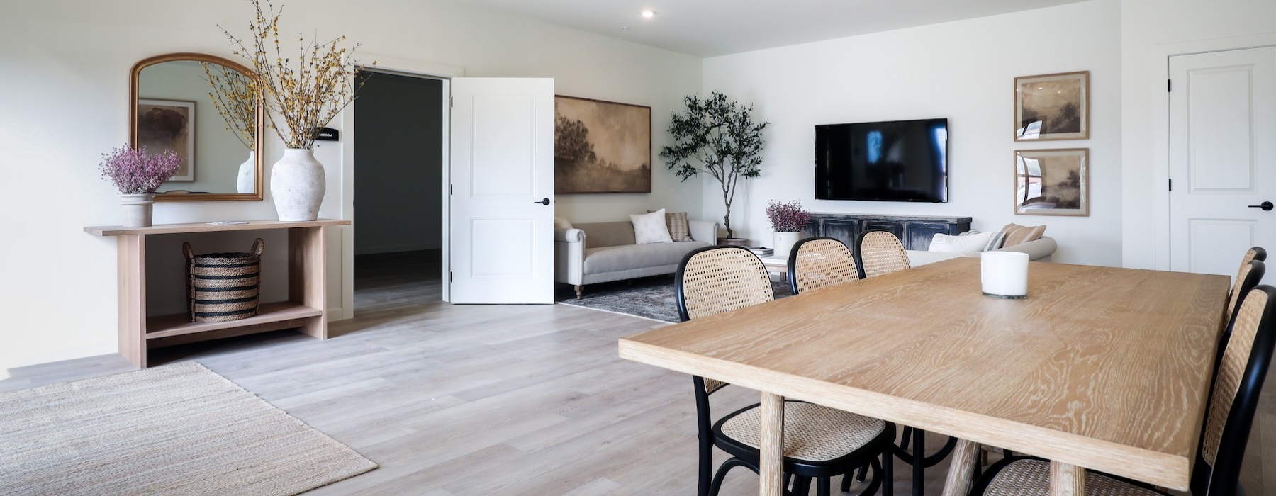 a large living room with a large table and chairs