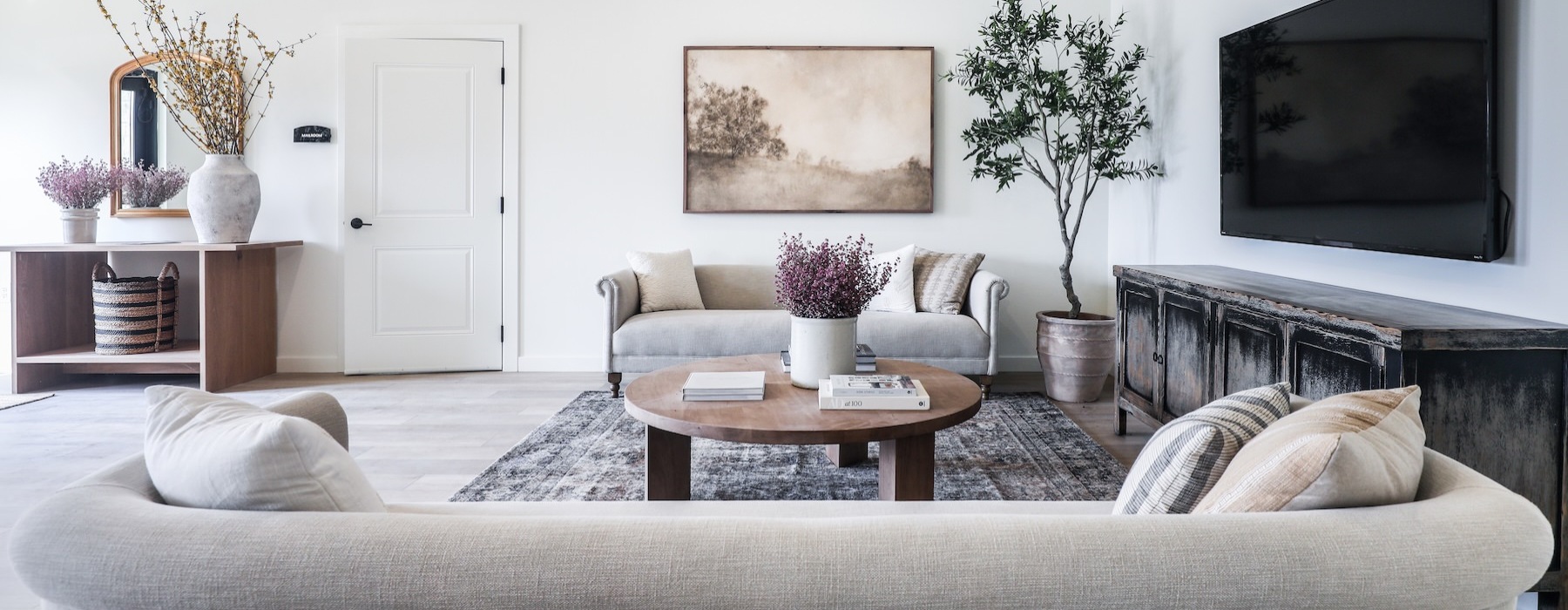 a living room with a tv and couches