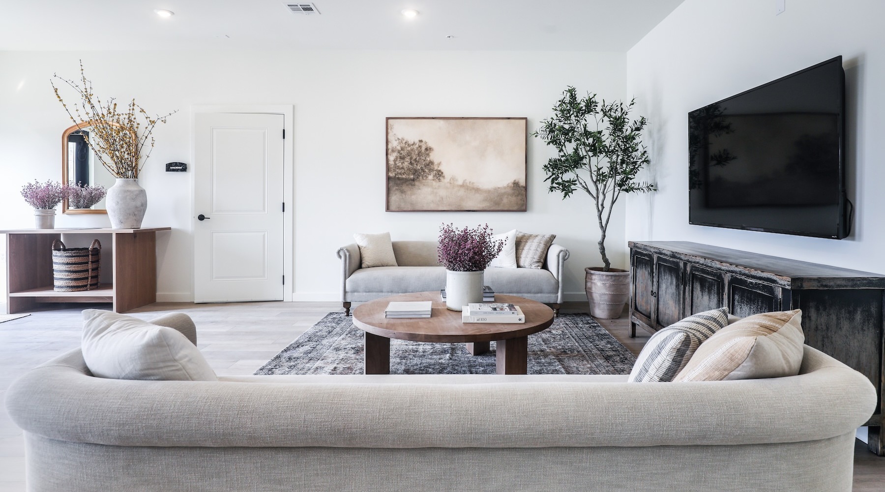 a living room with a tv and couches