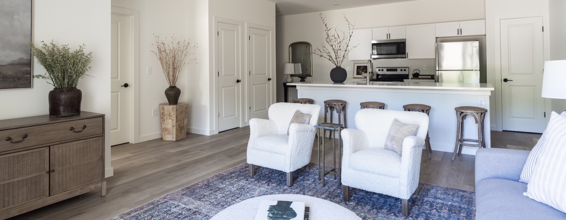 a living room with chairs and a couch